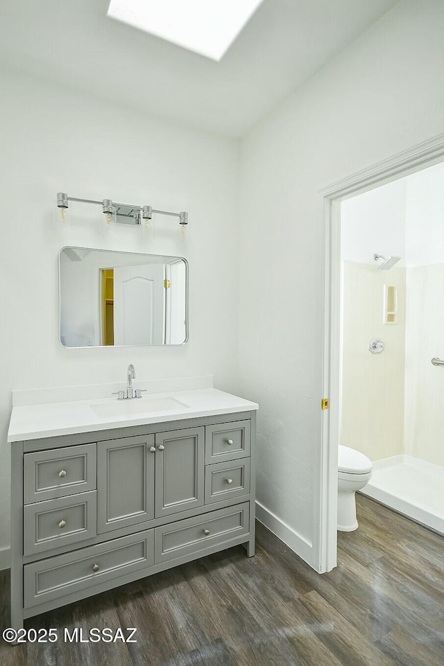 bathroom with vanity, hardwood / wood-style floors, and toilet