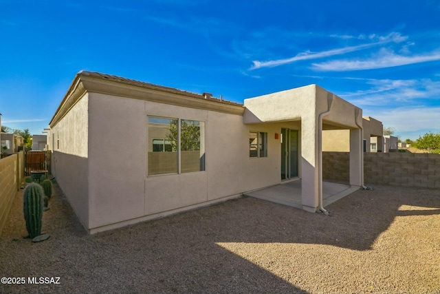 back of property with a patio