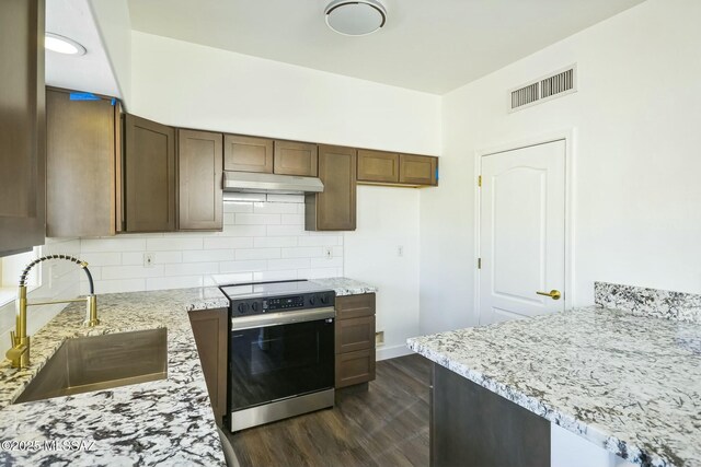 kitchen featuring range with electric stovetop, tasteful backsplash, sink, light stone counters, and dark wood-type flooring