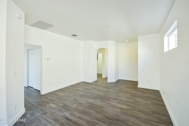 unfurnished room with dark hardwood / wood-style flooring