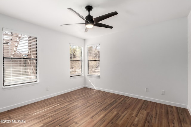 spare room featuring dark hardwood / wood-style floors and ceiling fan