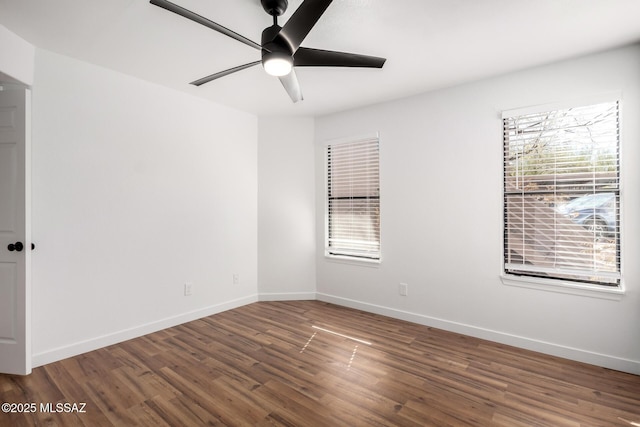 unfurnished room with dark wood-type flooring and ceiling fan