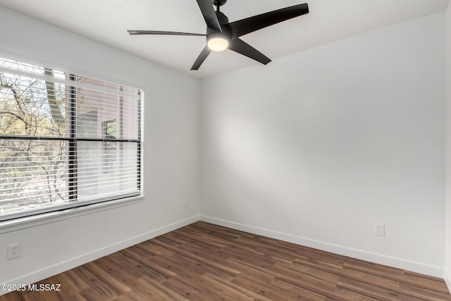 spare room featuring dark hardwood / wood-style flooring, a wealth of natural light, and ceiling fan