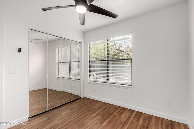 unfurnished bedroom with hardwood / wood-style floors, ceiling fan, and a closet