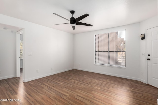 spare room featuring ceiling fan and dark hardwood / wood-style flooring