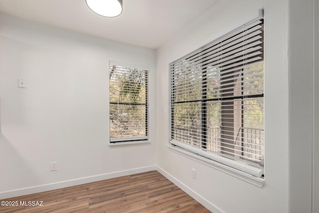 spare room with hardwood / wood-style flooring