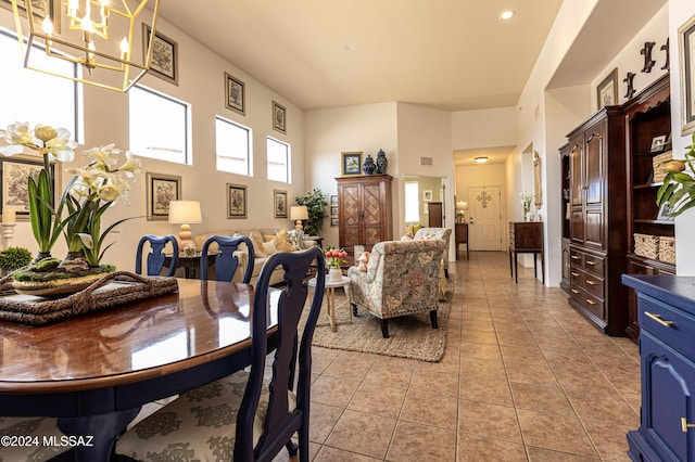 dining room featuring an inviting chandelier and light tile patterned flooring