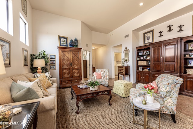 tiled living room featuring a high ceiling