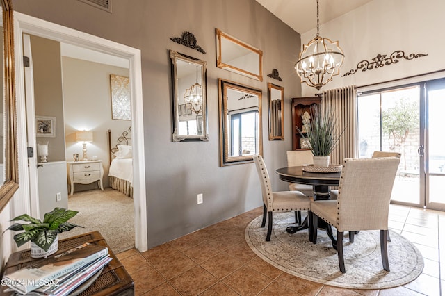 dining space featuring high vaulted ceiling, tile patterned floors, and a chandelier