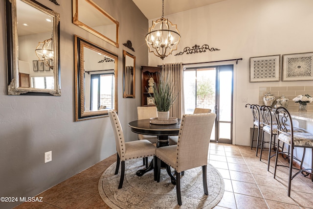 tiled dining room with an inviting chandelier and plenty of natural light