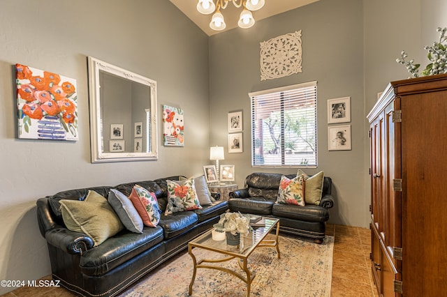 living room featuring an inviting chandelier, lofted ceiling, and light tile patterned floors