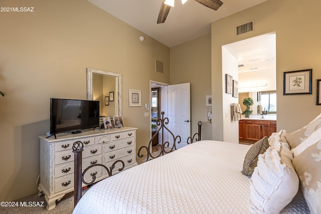 bedroom featuring ceiling fan, lofted ceiling, carpet flooring, and connected bathroom