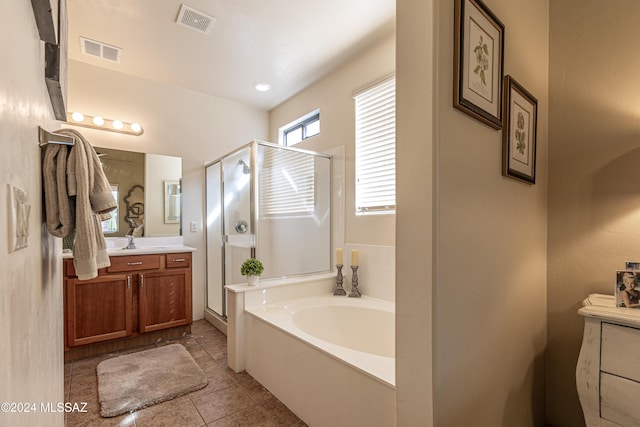 bathroom featuring tile patterned flooring, vanity, and shower with separate bathtub