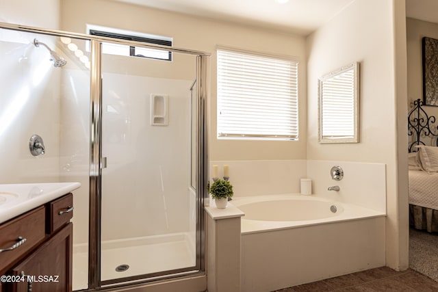 bathroom featuring tile patterned flooring, vanity, and separate shower and tub