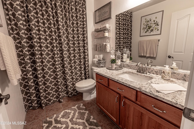 bathroom featuring vanity, toilet, and tile patterned flooring