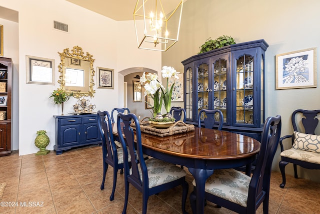 dining area with an inviting chandelier and tile patterned flooring