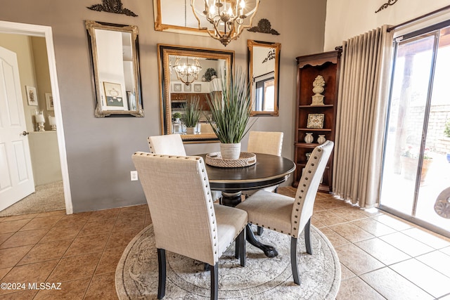 tiled dining area with plenty of natural light and an inviting chandelier