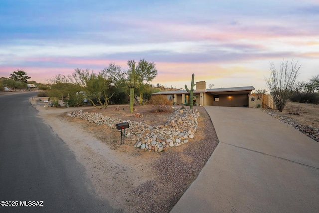 view of front of home with an attached garage and concrete driveway