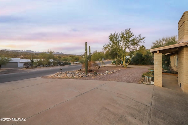 view of patio with driveway and a mountain view