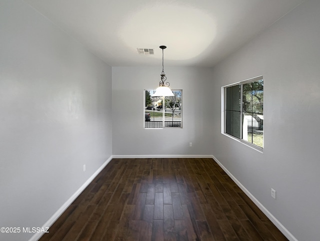 unfurnished dining area featuring dark hardwood / wood-style flooring and plenty of natural light