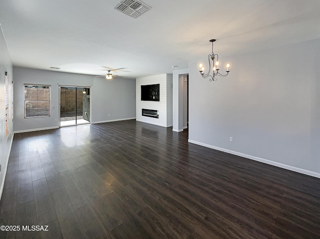 unfurnished living room with dark hardwood / wood-style flooring, ceiling fan with notable chandelier, and a large fireplace