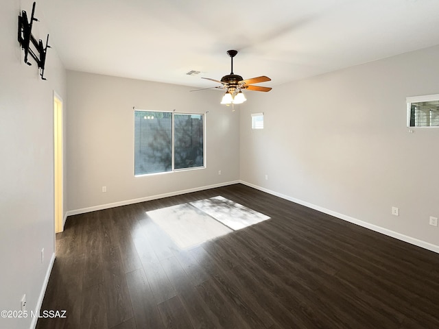 spare room featuring dark hardwood / wood-style floors and ceiling fan