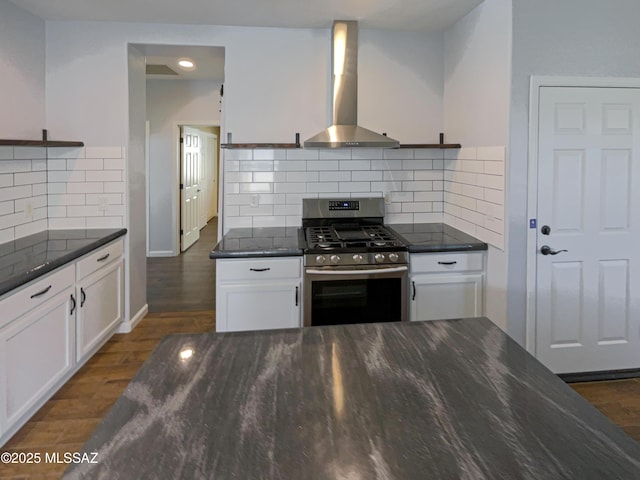 kitchen featuring white cabinets, dark hardwood / wood-style floors, ventilation hood, and stainless steel gas stove