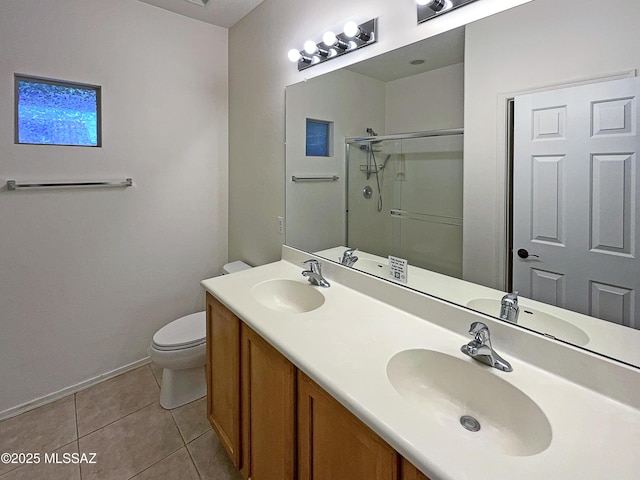 bathroom with vanity, a shower with shower door, tile patterned floors, and toilet