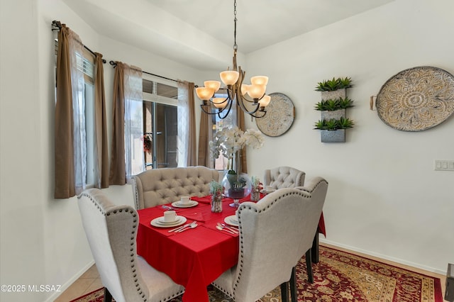 tiled dining area with a notable chandelier