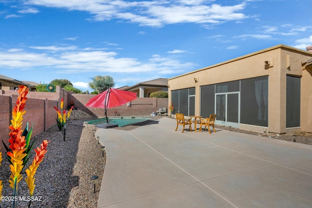 view of patio / terrace with a fenced in pool