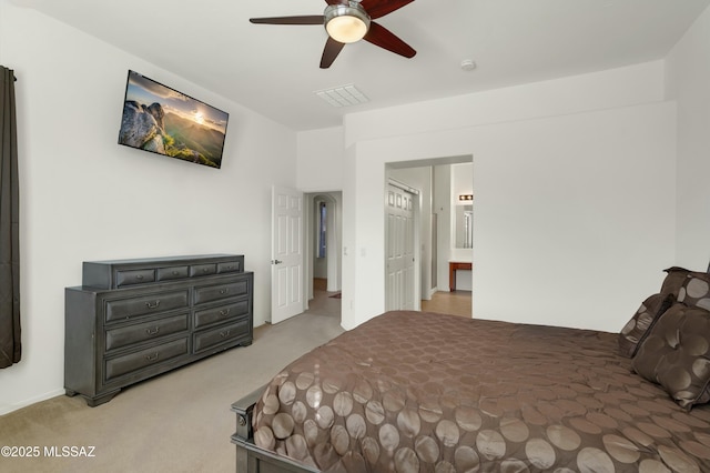 bedroom with carpet floors, ceiling fan, and ensuite bathroom