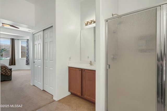 bathroom featuring vanity, tile patterned floors, a shower with door, and ceiling fan