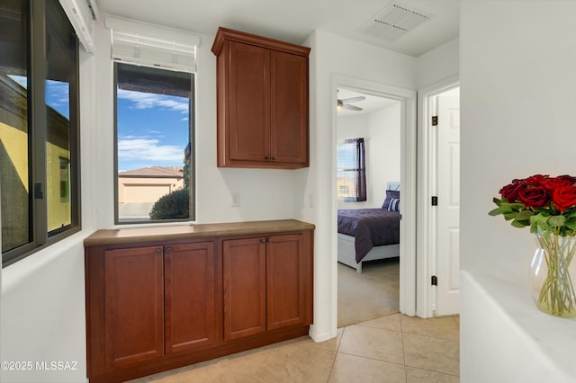 hall featuring light tile patterned floors and plenty of natural light