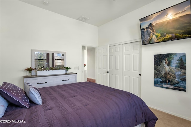 bedroom with a towering ceiling and carpet floors