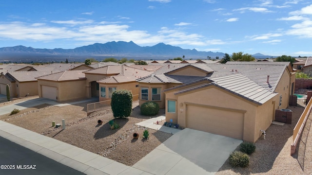 view of front of house with a garage and a mountain view