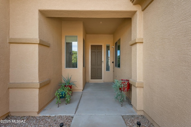 entrance to property featuring a patio area