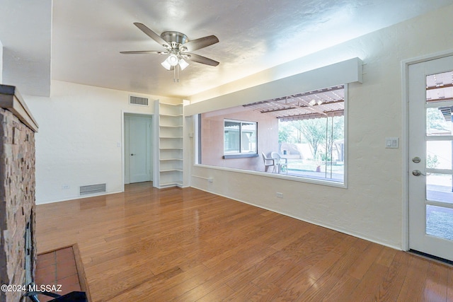 unfurnished living room featuring hardwood / wood-style floors and ceiling fan