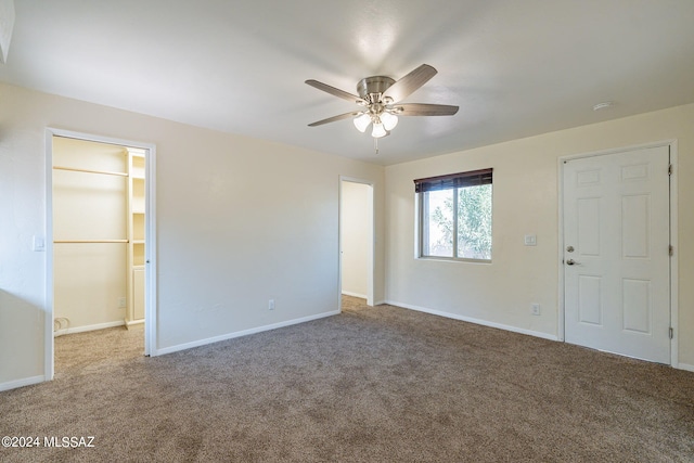 empty room featuring carpet floors and ceiling fan