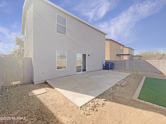 back of house with central AC unit and a patio