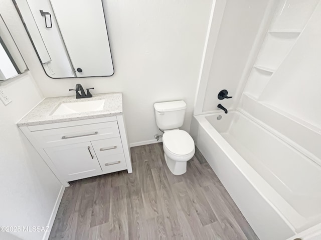 full bathroom with hardwood / wood-style flooring, vanity, bathing tub / shower combination, and toilet