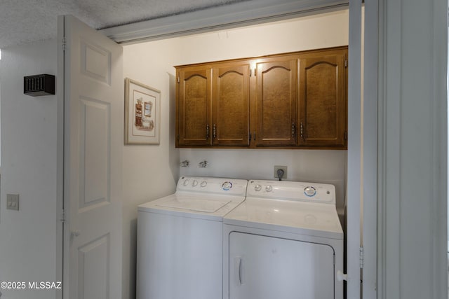 laundry room with cabinets and washing machine and dryer