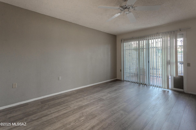 spare room featuring ceiling fan, hardwood / wood-style floors, and a textured ceiling