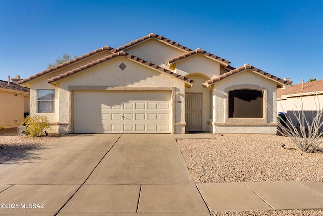 mediterranean / spanish house with a garage