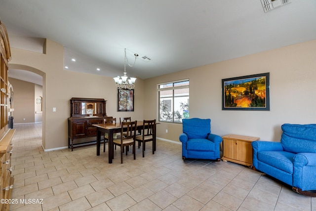 tiled dining space featuring a notable chandelier