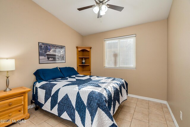 bedroom with vaulted ceiling, light tile patterned floors, and ceiling fan