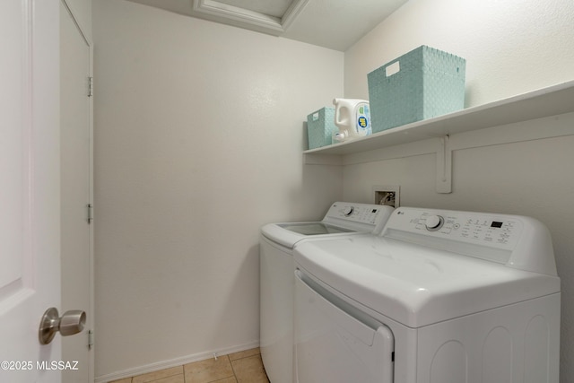 laundry room with separate washer and dryer and light tile patterned floors