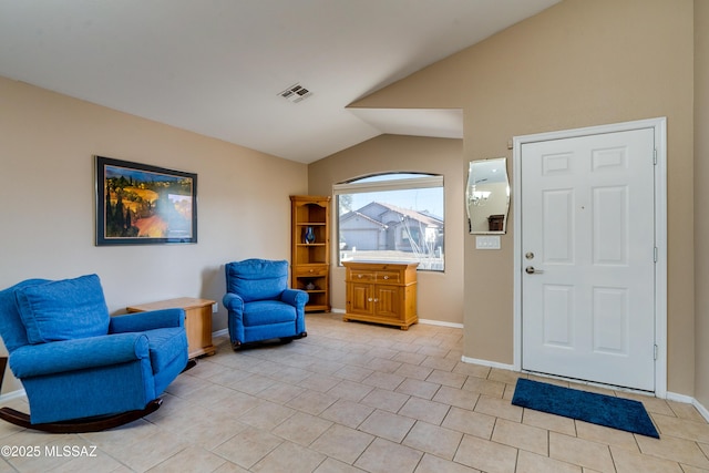 sitting room with lofted ceiling and light tile patterned flooring