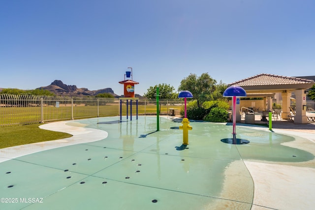 view of property's community featuring a mountain view and a yard