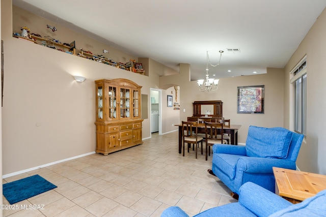 interior space featuring washer / dryer and a notable chandelier