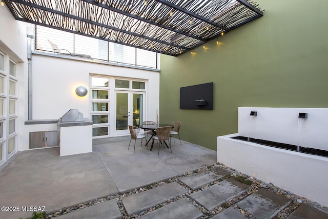 view of patio / terrace with area for grilling and a pergola